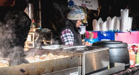 Dublin, Ireland - February 16, 2019: Live food stall where a cook prepares a meal in front of his client in the Temple Bar district on a winter dayのeditorial素材