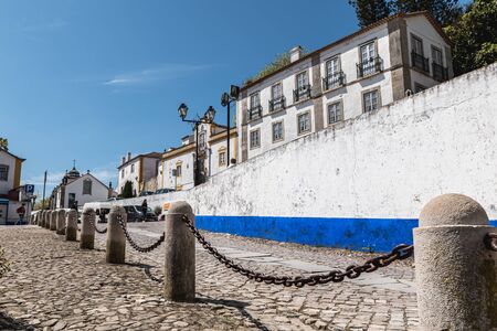 Obidos, Portugal - April 12, 2019: Architectural detail of small houses typical of the historic city...