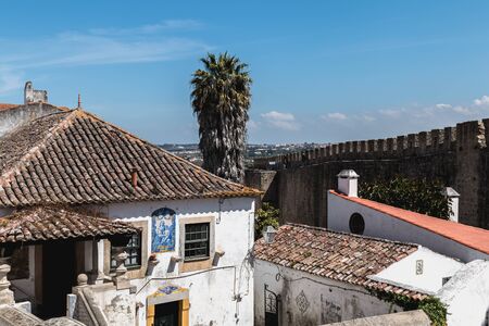 Obidos, Portugal - April 12, 2019: Architectural detail of small houses typical of the historic city...
