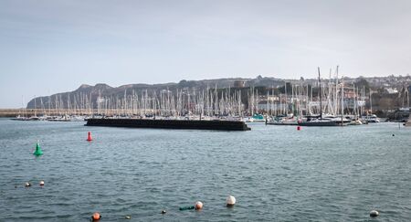 Howth near Dublin, Ireland - February 15, 2019: view of the marina of the city where are parked tourist boats on a winter dayのeditorial素材