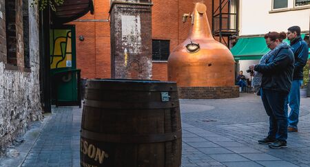 Dublin, Ireland - February 16, 2019: Tourists taking their picture in front of the old Jameson Brand...