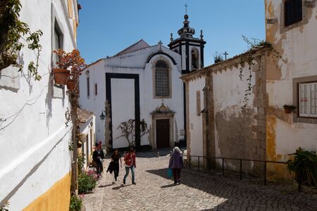 Obidos, Portugal - April 12, 2019: Architectural detail and street feel in the historic downtown that tourists visit on a spring dayのeditorial素材