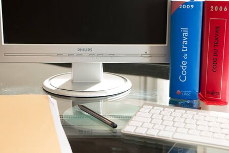 Paris, France - March 13, 2016: French labor code book is pictured with computer on a desk in studio...