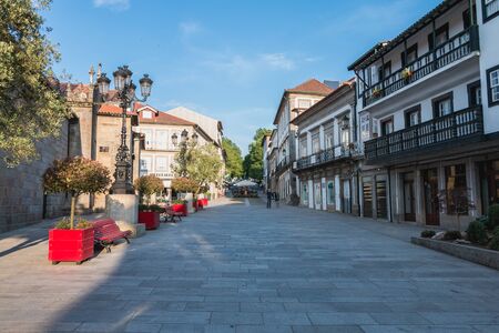 Ponte de Lima, Portugal - May 23, 2018: Detail of architecture and people walking in a pedestrian...