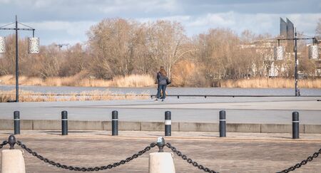 Bordeaux, France - January 26, 2018: People walking along the river Garonne near the city center on...