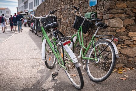 Port Joinville, France - September 16, 2018: Rental bike parked on a sidewalk in the harbor on a...