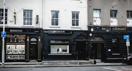 Dublin, Ireland - February 11, 2019: People walking down a shopping street with typical Irish architecture in the historic city center on a winter dayのeditorial素材