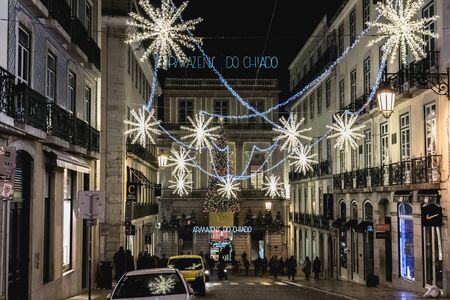 Lisbon, Portugal - November 27, 2018: Street atmosphere in the city center at night decorated for Christmas where people are walking on an autumn eveningのeditorial素材