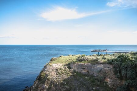 Albufeira, Portugal - May 3, 2018: People enjoying the sea view from the pontoon of a restaurant overlooking the beaches on a spring dayのeditorial素材