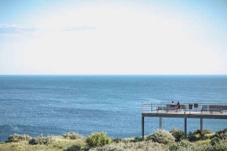 Albufeira, Portugal - May 3, 2018: People enjoying the sea view from the pontoon of a restaurant...