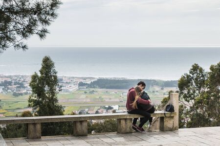 Vila Cha near Esposende - May 9, 2018: couple enjoying the panoramic view of Esposende on the entrance to the chapel of S. Lourenco on a spring dayのeditorial素材