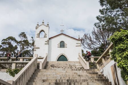 Vila Cha near Esposende - May 9, 2018: architectural detail of the chapel of S. Lourenco offering a panoramic view of Esposende with a young couple enjoying the view on a spring dayのeditorial素材