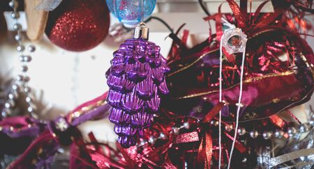Christmas decoration made by children garlands, balls and pine cone on a fir tree made from wooden...