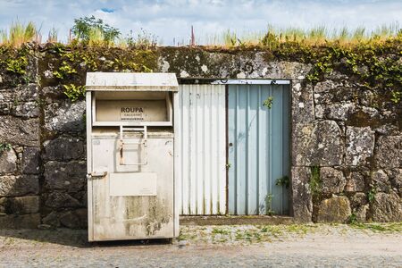 Vila Cha near Esposende, Portugal - May 9, 2018: Public containers for retrieving toy and clothes...