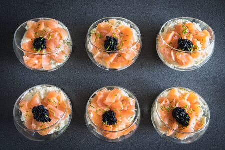 verrine salmon lumpfish egg fresh cheese and avocado bed in the kitchenの写真素材