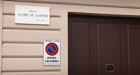 Como, Italy - November 4, 2017: road sign prohibiting parking (Passo Carrabile) next to a garage...