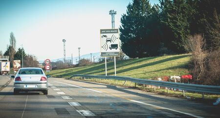 A36 motorway near Mulhouse, France - December 25, 2017: car passing in front of a road sign...