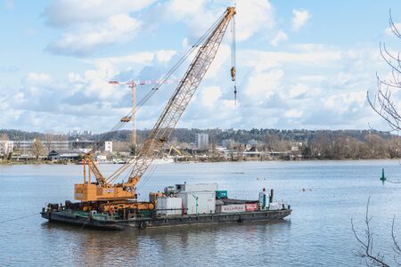 Bordeaux, France - January 26, 2018: Floating construction barge with a crane on the Garonne river in the city center in winter dayのeditorial素材