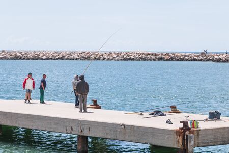 Vilamoura, Portugal - May 1, 2018: Fishermen by the sea coming together to enjoy the good weather on a spring dayのeditorial素材