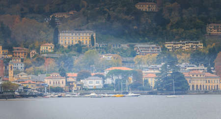 Como near Milan, Italy - November 4, 2017: Passenger seaplane landing on Lake Como among small fisherman boats on an autumn dayのeditorial素材