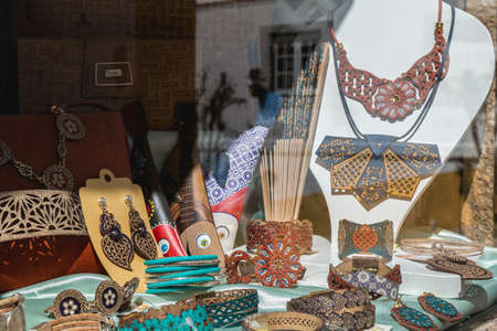 Obidos, Portugal - April 12, 2019: View of the window of a souvenir shop on a spring day with its reproductions of objects and clothing accessories formerly worn in historic cityのeditorial素材