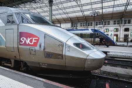 Tours, France - February 8, 2020: train at platform where people walk inside Tours train station in the city center on a winter dayのeditorial素材