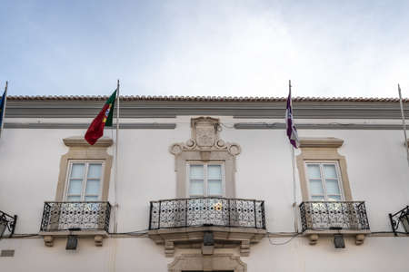 Loule, Faro, Portugal - February 25, 2020: detail of architecture of the city hall in the historic city center where people walk on a winter dayのeditorial素材