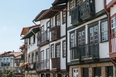 Guimaraes, Portugal - May 10, 2018: Architecture detail of houses typical of the small streets of the historic city center that tourists visit on a spring dayのeditorial素材