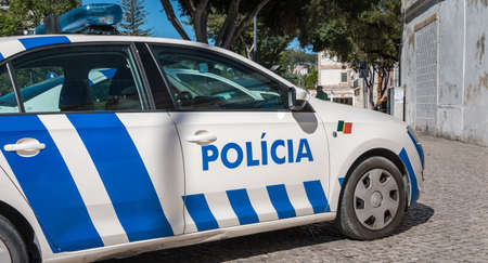 Setubal, Portugal - August 8, 2018: Portuguese police car parked in the historic city center on a...
