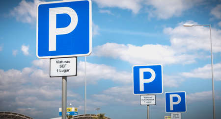 Faro, Portugal - May 3, 2018: parking sign reserved for government vehicles (SEF 1 place, ALFANDEGA 1 place, ANA SA 2 places) in front of Faro International Airport on a spring dayのeditorial素材