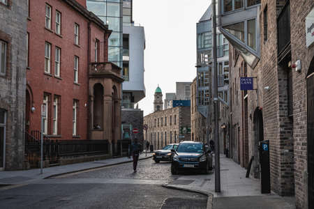 Dublin, Ireland - February 16, 2019: people walking down a small street with typical architecture of small downtown areas on a winter dayのeditorial素材