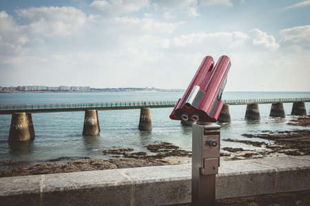 Sables d Olonne, France - October 13, 2015 : binocular telescope for tourist pointed to the beach on...