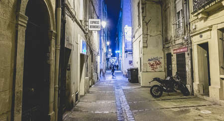 Montpellier, France - January 2, 2019: Street atmosphere at night in a pedestrianized street in the historic city center where people walk on a winter dayのeditorial素材