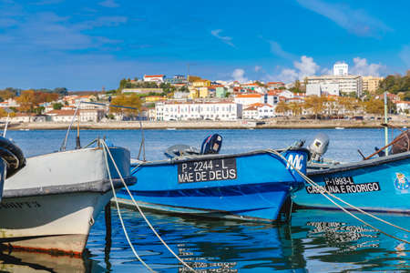 Porto, Portugal - October 23, 2020: Small fishing boats in the fishing port of Afurada at the exit of the mouth of the Douro river on an autumn dayのeditorial素材