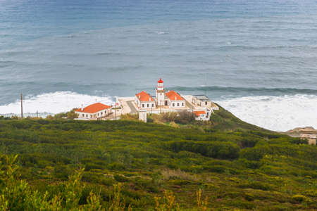 Figueira da Foz, Coimbra, Portugal - October 25, 2020: Architecture and environment of Cabo Mondego lighthouse facing the ocean in bad weather on an autumn dayのeditorial素材