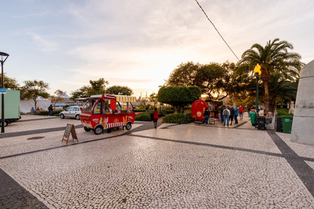 Funchal, Madeira, Portugal - December 31, 2021: Ice cream peddler in a tourist square near the port...