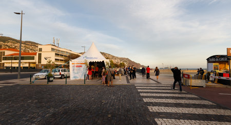 Funchal, Madeira Island, Portugal - December 31, 2021: People waiting in front of a mobile COVID test tent on the port of Funchal before the New Year's Day fireworks display in winterのeditorial素材