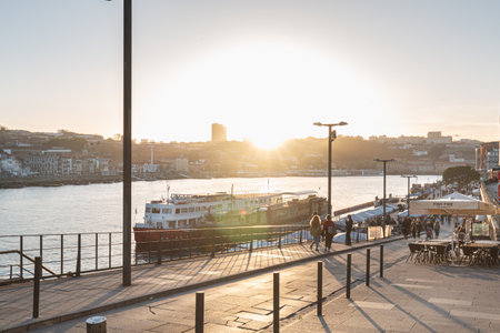 Porto, Portugal - November 30, 2018: Street atmosphere near the Dom Luiz bridge with its cafe terrace and its traders where people are walking on an autumn dayのeditorial素材