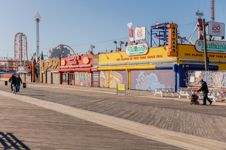 New York City, Brooklyn, USA - February 18, 2023: street atmosphere in front of closed Coney Island attractions with people walking on a winter dayのeditorial素材