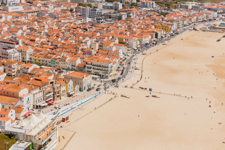 Aerial view of the city of Nazare, Portugal and the Praia da Nazare beach on a sunny spring dayの写真素材