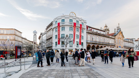 Braga, Portugal - December 24, 2025: Historic city center decorated for the Christmas holidays where people stroll on a winter eveningのeditorial素材
