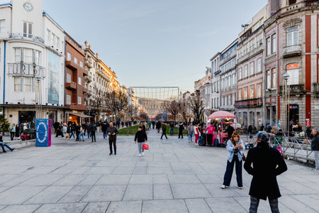 Braga, Portugal - December 24, 2025: Historic city center decorated for the Christmas holidays where people stroll on a winter eveningのeditorial素材