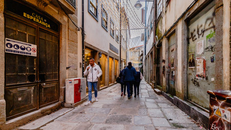 Braga, Portugal - December 24, 2025: Historic city center decorated for the Christmas holidays where people stroll on a winter eveningのeditorial素材