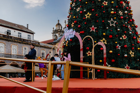 Braga, Portugal - December 24, 2025: Historic city center decorated for the Christmas holidays where people stroll on a winter eveningのeditorial素材