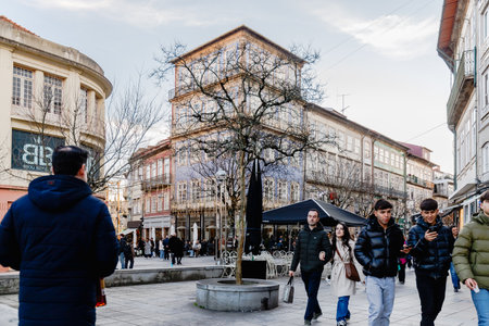 Braga, Portugal - December 24, 2025: Historic city center decorated for the Christmas holidays where people stroll on a winter eveningのeditorial素材