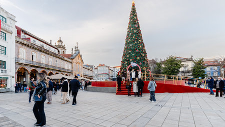 Braga, Portugal - December 24, 2025: Historic city center decorated for the Christmas holidays where people stroll on a winter eveningのeditorial素材