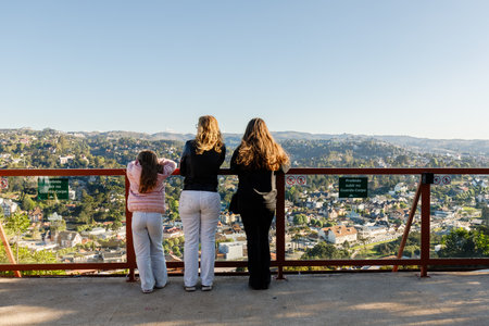 Campos do Jordao, Brazil - October 22, 2025: Tourists viewing an aerial view of the city center on a...
