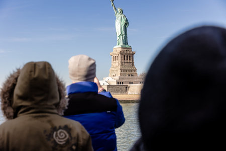 New York City, USA - February 13, 2023 - Tourists taking photos of the Statue of Liberty aboard a ferry from Manhattan to Liberty Island on a winter dayのeditorial素材