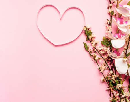 Spring layout with flower and heart made of pink ribbon on purple background. Spring conceptの写真素材