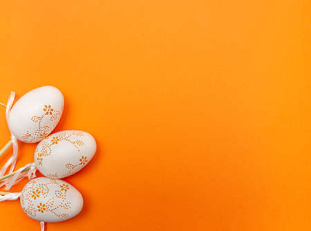 White Easter eggs on orange background. Spring holidays conceptの写真素材